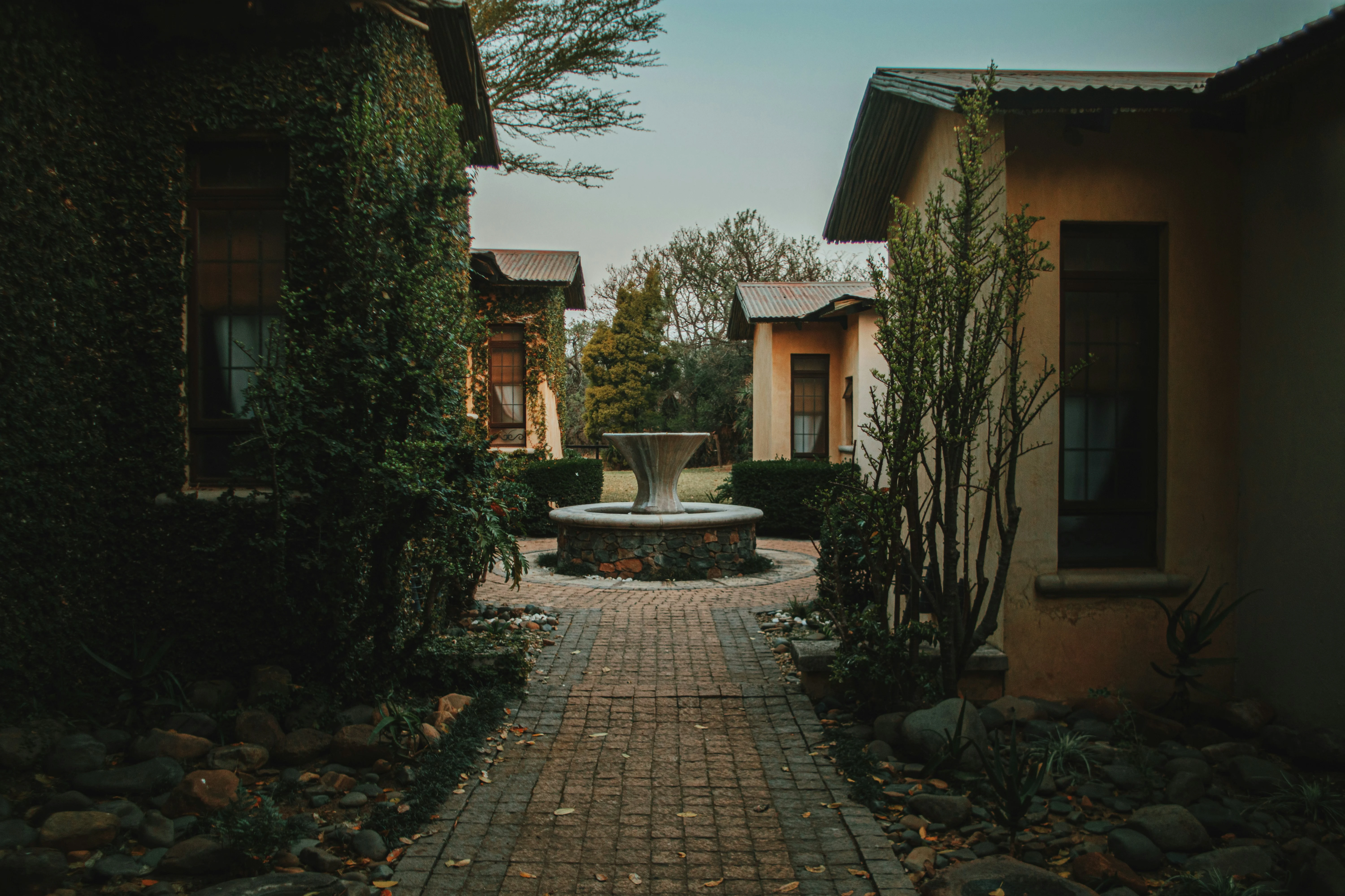 The lodge at dusk, lamps lit along the path