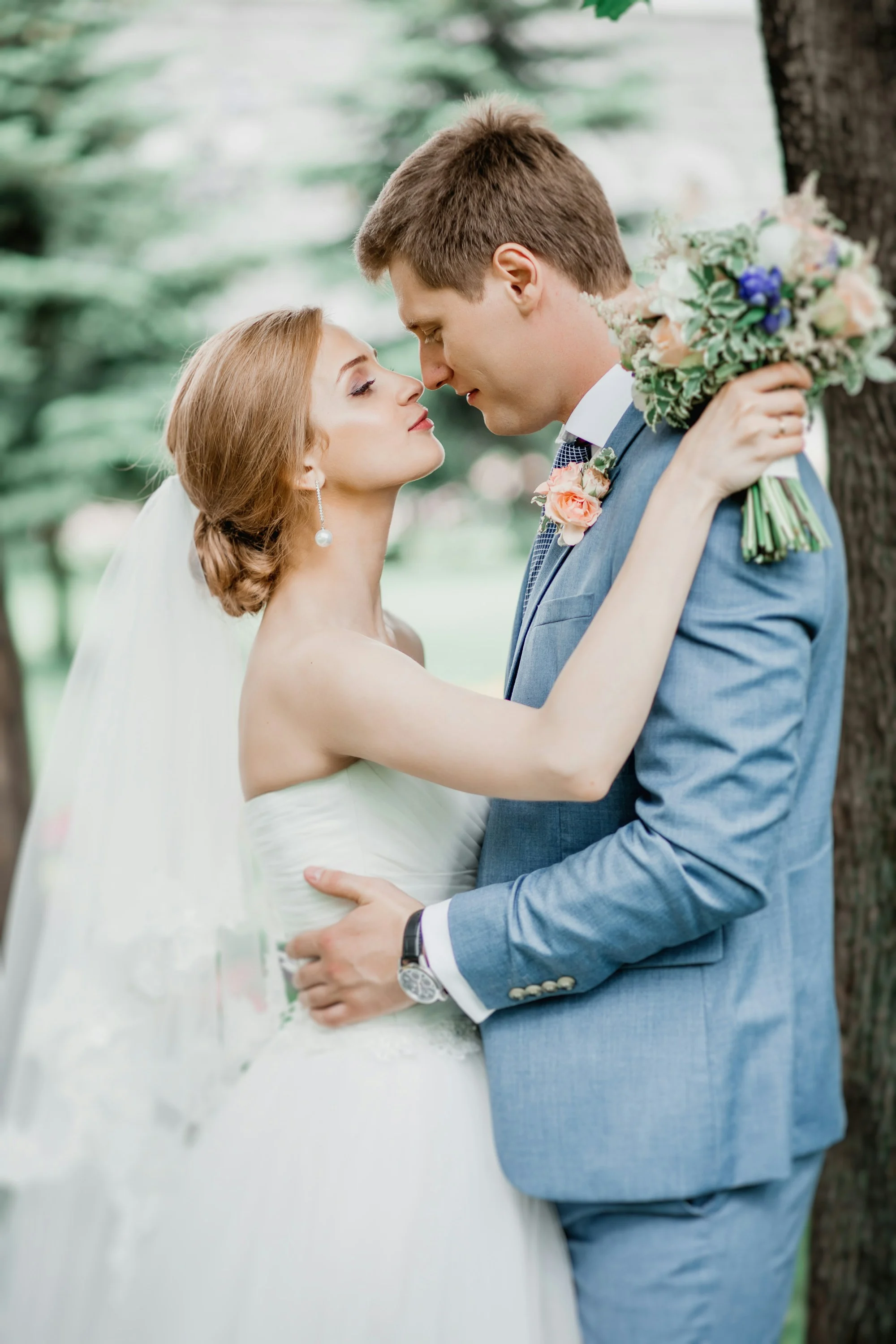 Forehead to forehead, holding the bouquet